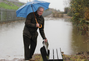 Horace Prickett next to the flooded pond